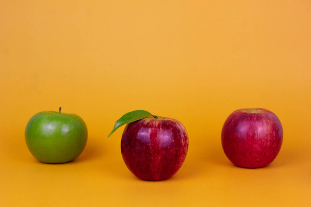 Three different apples green and red fruits isolated on yellow background. Healthy fruits concept ads. and green food for heath - Φωτογραφία, εικόνα