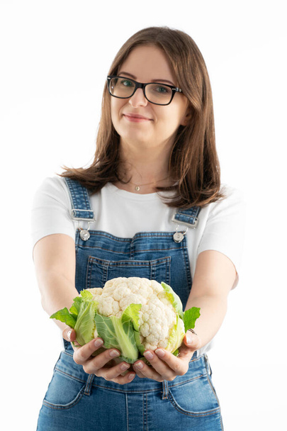 Young happy woman with fresh cauliflower. Choosing a healthy diet and life style. - Photo, image