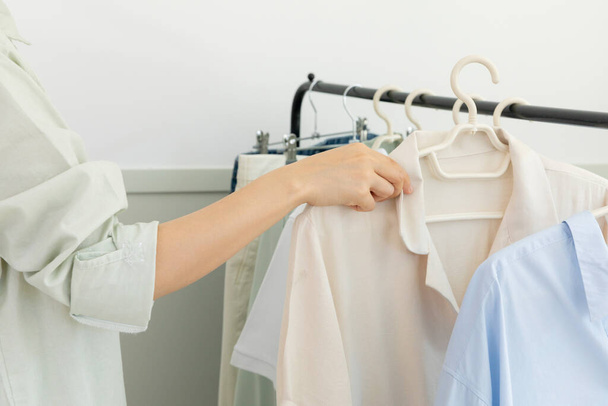 aesthetic laundry concept, clothes hung on a hangers - Fotó, kép