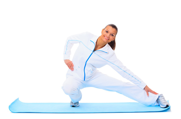 Fitness woman making a break in tailor-seat on white background - Photo, image