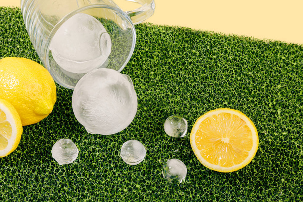 creative summer photo of ice and lemon, yellow background - Φωτογραφία, εικόνα