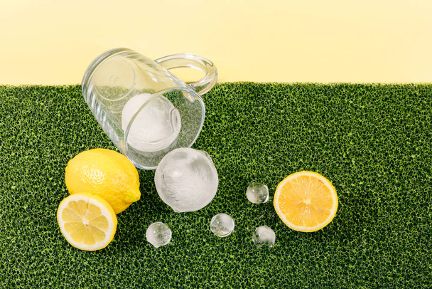 creative summer photo of ice and water cup, yellow background - Foto, imagen