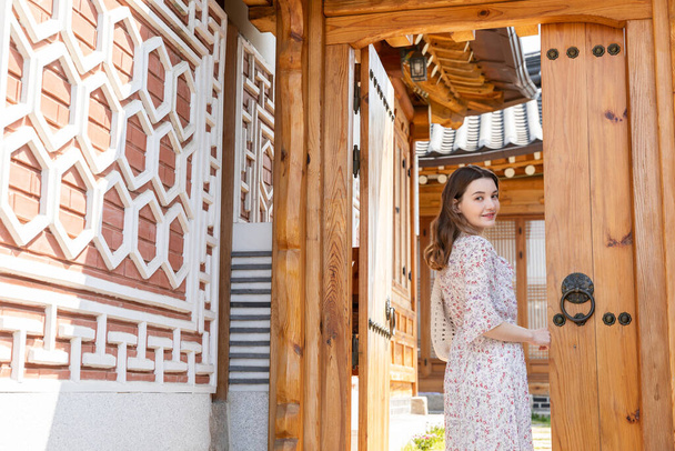 Experience Hanok, Korean traditional house_caucasian girl opening the door - 写真・画像