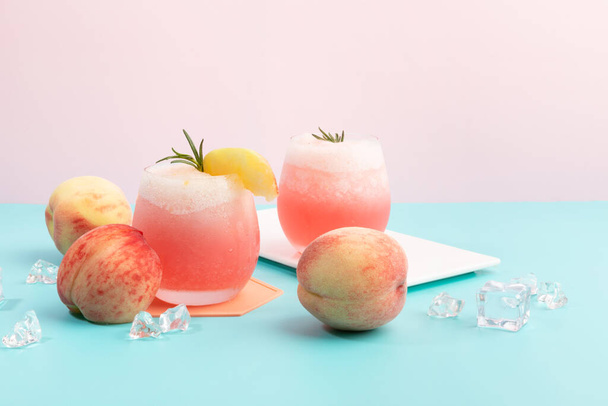 summer background with peach ade drink with peaches fruit - 写真・画像