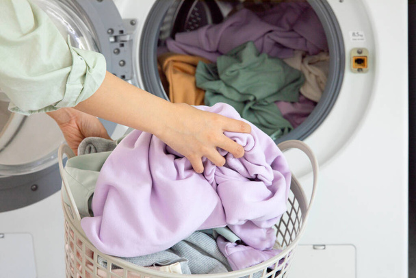 aesthetic laundry concept, Putting laundry into the washing machine - Фото, изображение