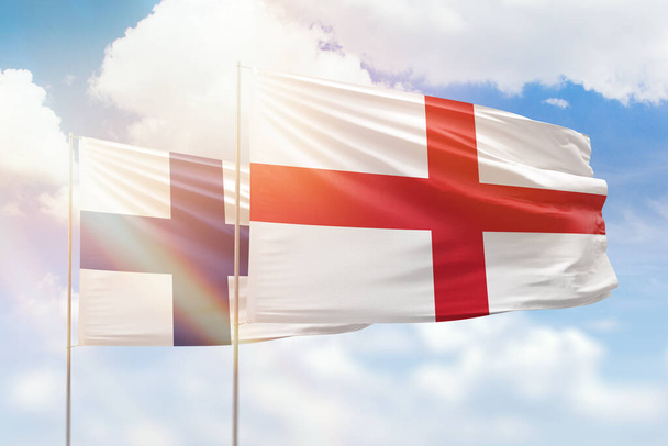 Sunny blue sky and flags of england and finland - Valokuva, kuva