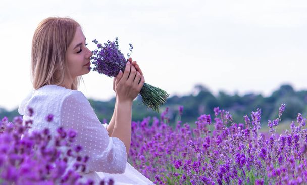 the girl is resting in the lavender field. selective focus - Fotó, kép