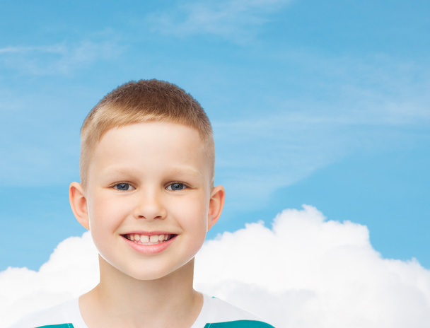 smiling little boy over green background - Фото, изображение