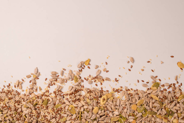 Mix of seeds for a salad. A pile of mixed seeds isolated on a white background.  - Photo, image