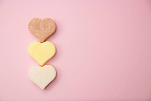 Heart shaped pink bar of soap on a light pink background. Top view, copy space. Heart shaped soaps. Importance of personal hygiene care. Copy space - Foto, Imagem