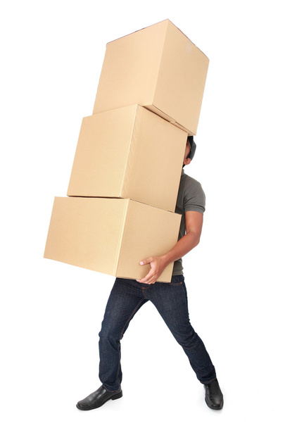 Man Holding some heavy Stack Of Cardboard Boxes - Foto, Imagen