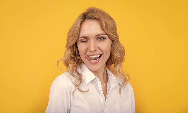 glad blonde woman with curly hair on yellow background. - Photo, Image