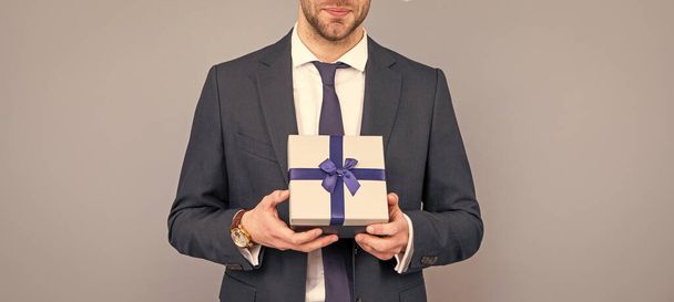 cropped business man hold gift box. boxing day. businessman in suit with present box. shopping sale and discount. - 写真・画像