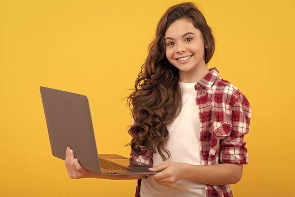 happy smart teen girl hold laptop during school online lesson, wireless technology. - Фото, зображення