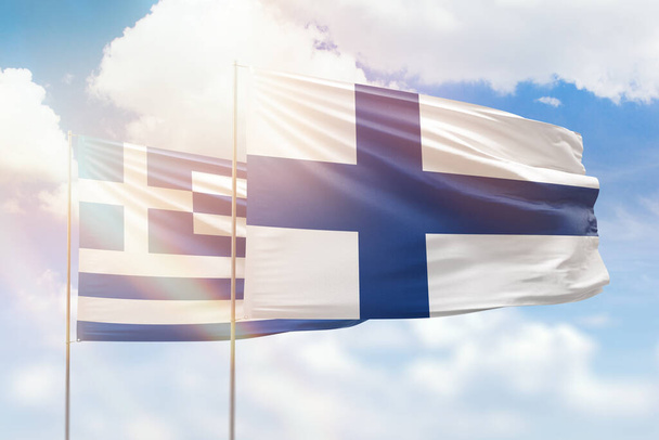 Sunny blue sky and flags of finland and greece - 写真・画像
