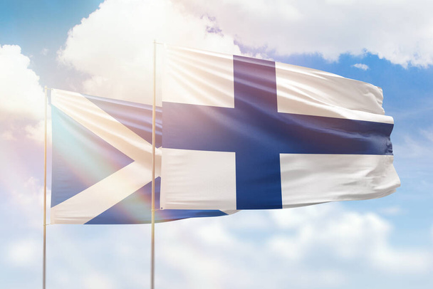 Sunny blue sky and flags of finland and scotland - Zdjęcie, obraz