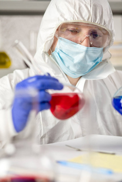 Scientist holding test tube with liquid reagent. Lab scientist and chemical laboratory   glassware - Foto, Bild