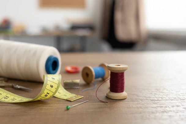 糸のスプールとテールでツールとテーラーメイドや縫製アクセサリー。服工房のコンセプト - 写真・画像
