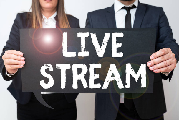 Sign displaying Live Stream, Word Written on transmit or receive video and audio coverage over Internet Business Team Holding Important Information On Speech Bubble On Both Sides. - Zdjęcie, obraz