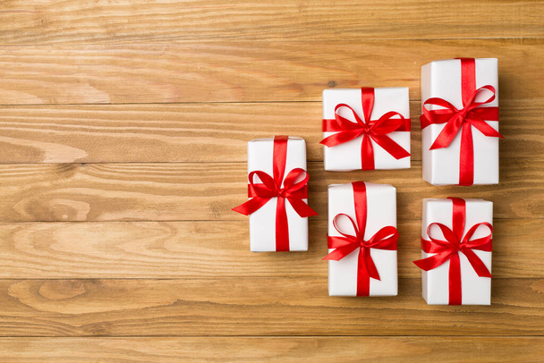 Top view of gift boxes on wooden background. - Foto, Bild