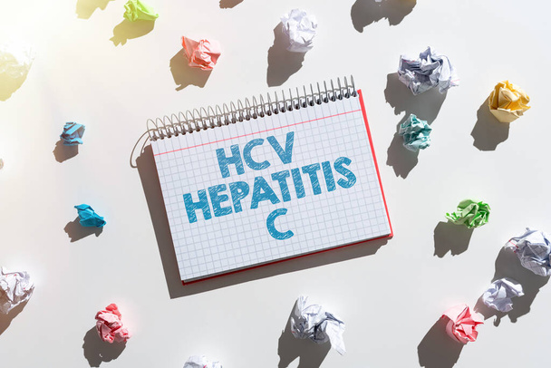 Sign displaying Hcv Hepatitis C, Word Written on Liver disease caused by a virus severe chronic illness Notebook With Important Messages Surrounded By Paper Wraps. - Fotografie, Obrázek