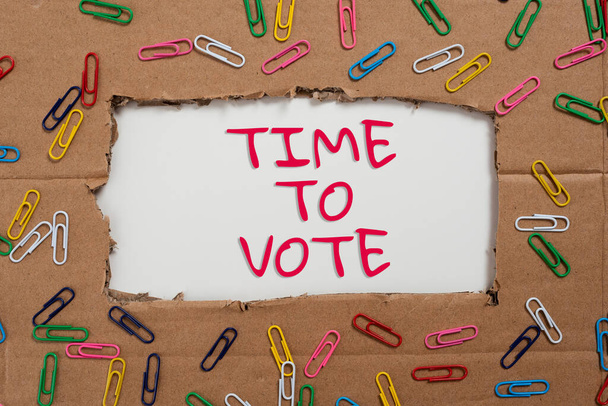 Text caption presenting Time To Vote, Business showcase Election ahead choose between some candidates to govern Important Ideas Written Under Ripped Cardboard With Paperclips Around. - Photo, Image