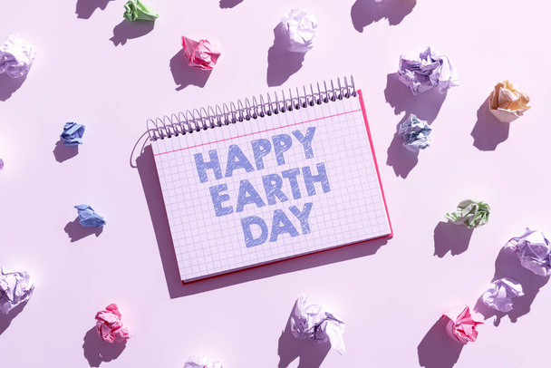 Text caption presenting Happy Earth Day, Business showcase Worldwide celebration of ecology environment preservation Notebook With Important Messages Surrounded By Paper Wraps. - Фото, изображение