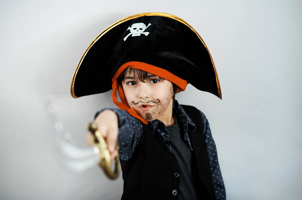 Can you tell that this a costume. a little boy wearing a pirate costume against a white background - Photo, image