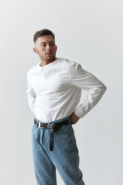Handsome pensive attractive serious model man guy wear linen shirt looks aside posing isolated on white studio background. Fashion Style New Collection Sale ad concept. Copy space, banner. Model shoot - Foto, imagen