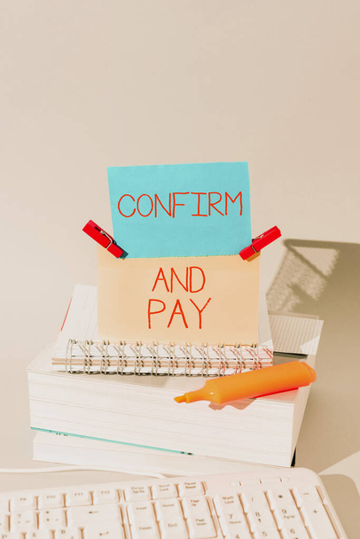 Text sign showing Confirm And Pay, Business concept Check out your purchases and make a payment Confirmation Important Messages Presented On Piece Of Paper On Desk With Books. - Φωτογραφία, εικόνα