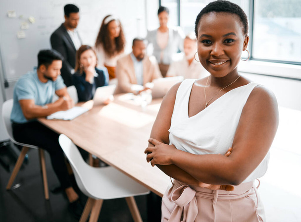 Who wouldnt wanna be a part of this team. Cropped portrait of an attractive young businesswoman attending a meeting in the boardroom with her colleagues in the background - Fotó, kép
