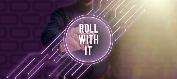 Text sign showing Roll With It, Word Written on Going along with things without having high expectations Businessman in suit holding notepad symbolizing successful teamwork. - Photo, image