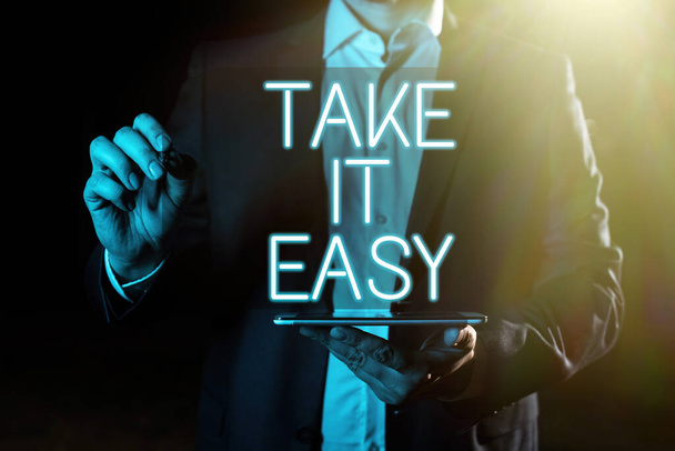 Sign displaying Take It Easy, Business overview Be relaxed do not worry about things stay calmed and rest Hand With Pen Pointing Important Infortmations With Other Holding Tablet - Φωτογραφία, εικόνα