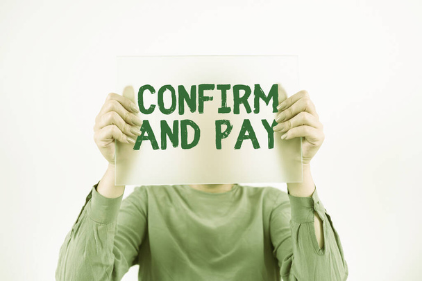 Sign displaying Confirm And Pay, Conceptual photo Check out your purchases and make a payment Confirmation Woman Holding Banner And Promoting The Company Brand To Achieve Goals. - 写真・画像