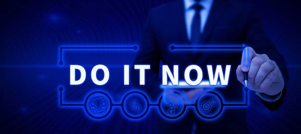 Text sign showing Do It Now, Business showcase Respond Immediately Something needs to be done right away Businessman in suit holding open palm symbolizing successful teamwork. - Foto, Imagem