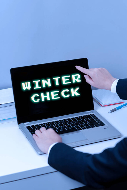 Conceptual caption Winter Check, Business concept Coldest Season Maintenance Preparedness Snow Shovel Hiemal Woman Typing Updates On Lap Top And Pointing New Ideas With One Finger. - Foto, Bild