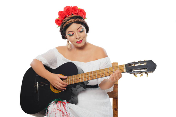 Mexican woman made up with Mexican flag colors wearing white dress. Mexican woman with guitar on white background. - Photo, Image