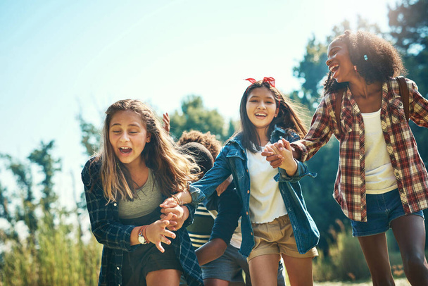 Hold onto your hats, summer camp is here. a group of teenagers having fun at summer camp - 写真・画像