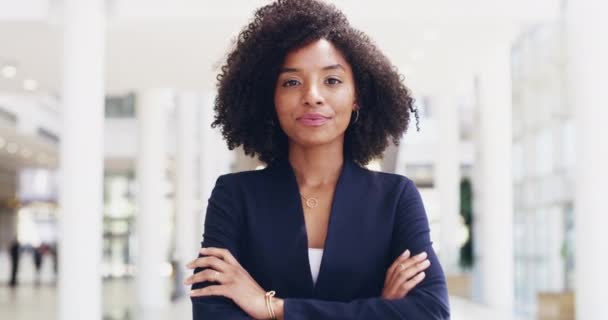 Young, confident and professional business woman laughing while standing in the office with her arms crossed. Portrait of a beautiful, young and happy female looking positive and smiling at work. - Metraje, vídeo