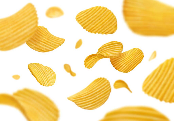 Flying and falling crispy ripple potato chips. Floating salty snack, flying crunchy and potato chips, 3d realistic junk food meal vector crispy chips background with blur and bokeh effect - Vektor, Bild