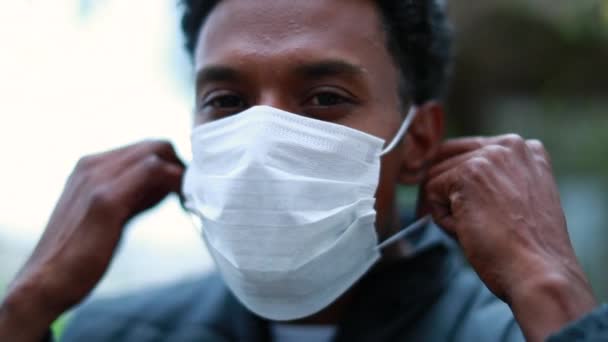 Black african american man removing covid surgical mask outside - Footage, Video