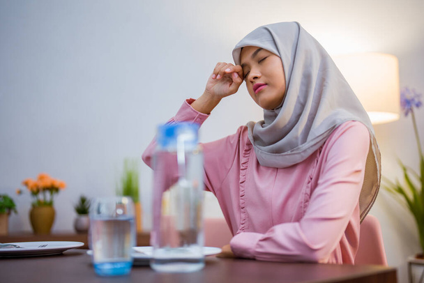 tired muslim woman wake up early to have a morning breakfast on fasting month. sahur concept in ramadan - Fotografie, Obrázek