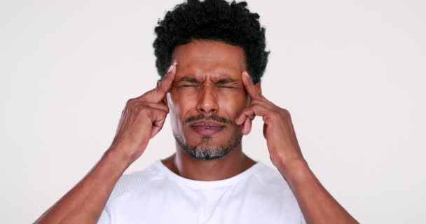 Person having a headache. Black man feeling pain and worry - Záběry, video