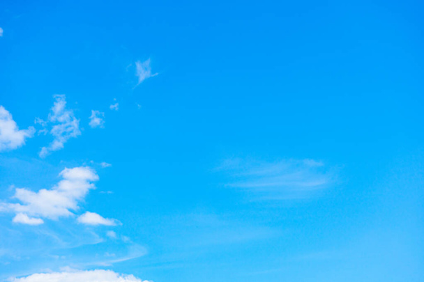 Several small white clouds on a blue sky background. - Foto, imagen