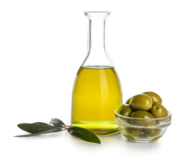 Bottle of fresh oil and bowl with olives isolated on white background - Foto, imagen