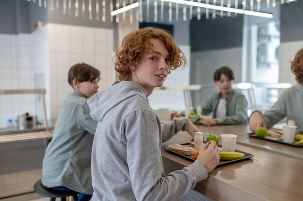Friends at lunch. Two school boys having lunch in a school canteen - Fotoğraf, Görsel