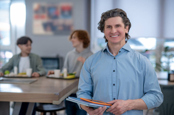 School canteen. A smiling male teacher in a school canteen - Foto, afbeelding