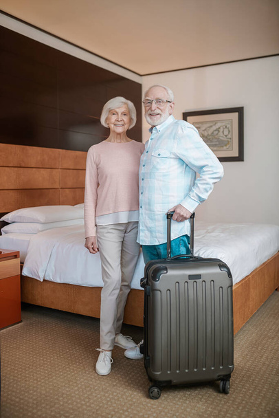 Happy couple. Senior happy couple in a hotel room looking cheerful and excited - Fotoğraf, Görsel