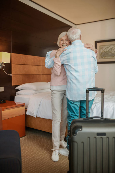 Happy couple. Gray-haired couple embracing and feeling happy - 写真・画像