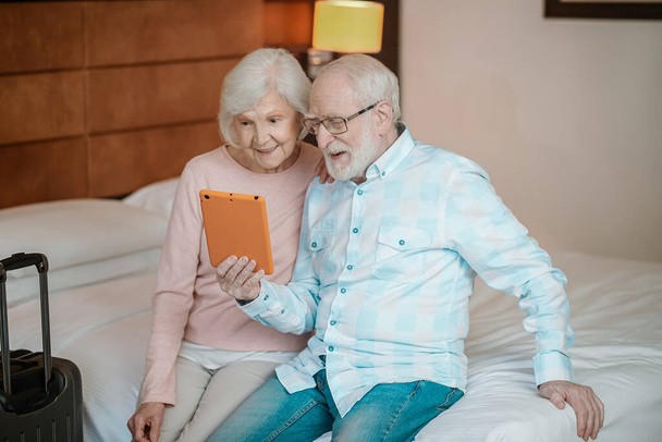 Excitement. Senior man and woman watching something online and looking excited - Photo, image